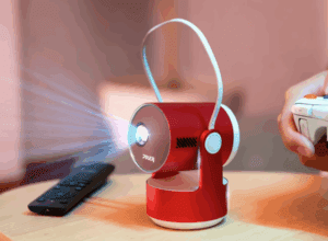 a red camera with a light coming out of it