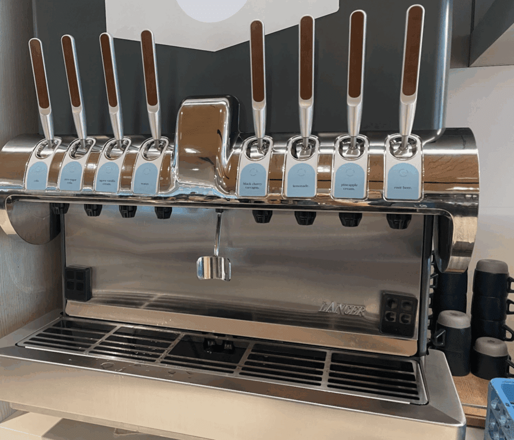 a group of silver and brown handles on a metal machine