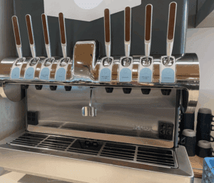 a group of silver and brown handles on a metal machine