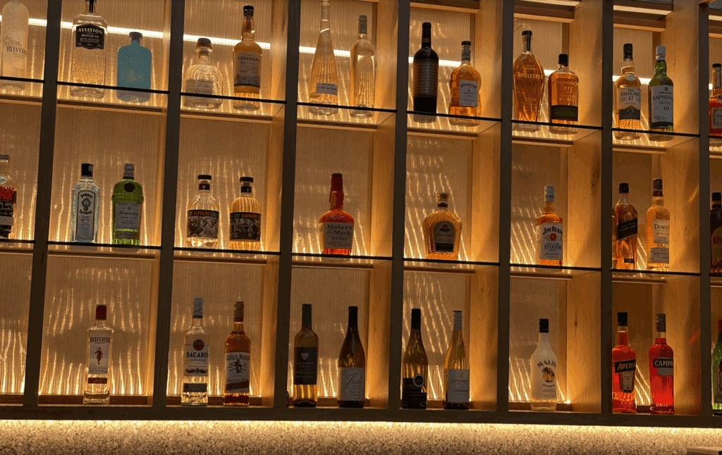 a shelf with bottles of alcohol