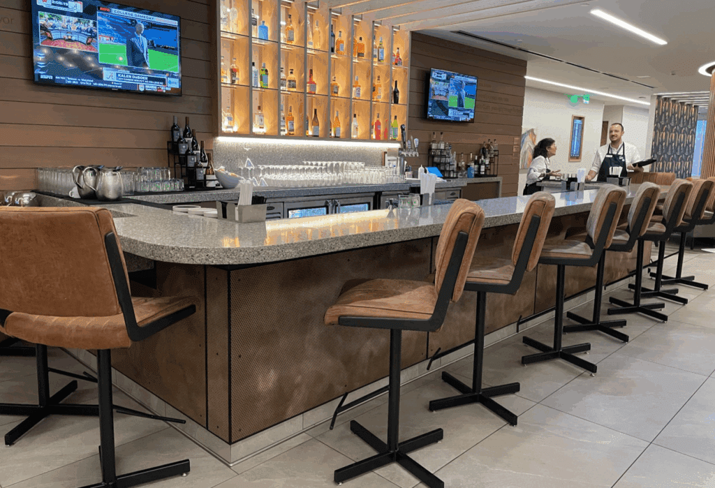 a bar with chairs and a tv on the wall