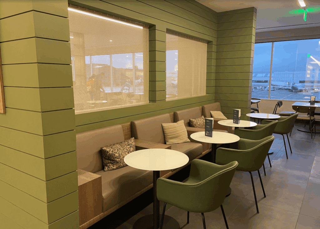 a room with green walls and tables and chairs