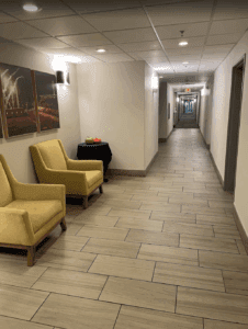 a hallway with chairs and a table