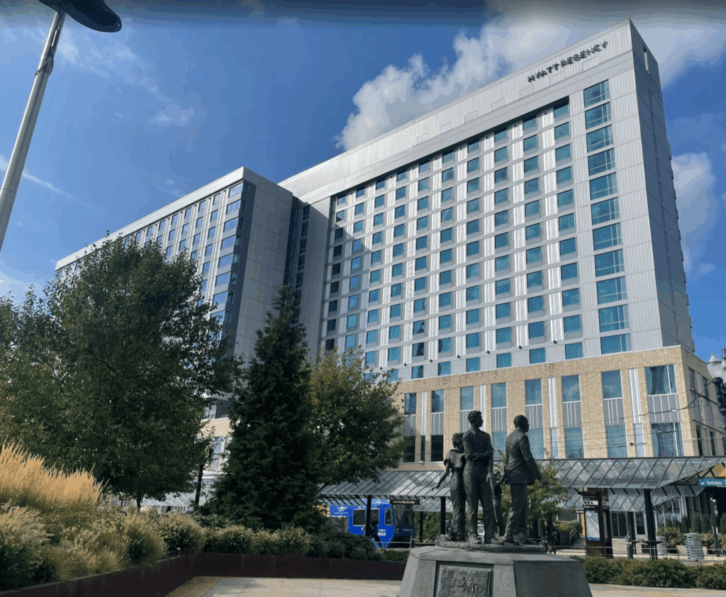 a statue of people in front of a large building