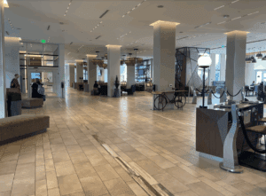 a large lobby with a large counter and a couple people