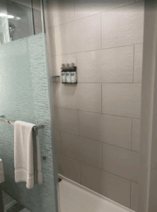 a shower with a towel and a rack