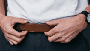 a person putting on a belt