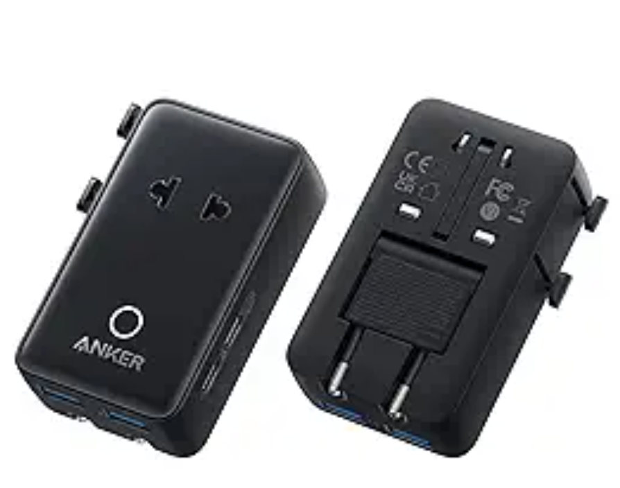 a black rectangular object with buttons and a couple of plugs
