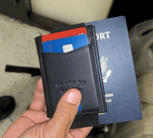 a hand holding a wallet with credit cards in it