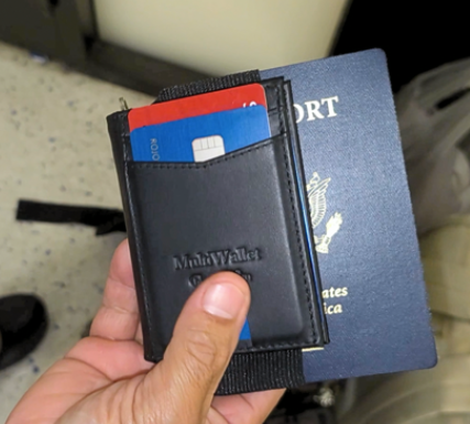 a hand holding a wallet with credit cards in it