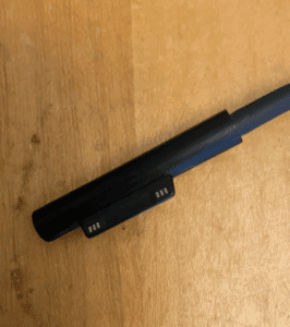 a black pen on a wood surface