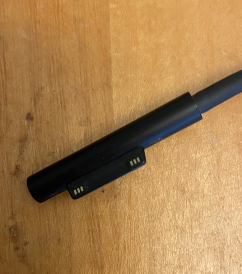 a black pen on a wood surface