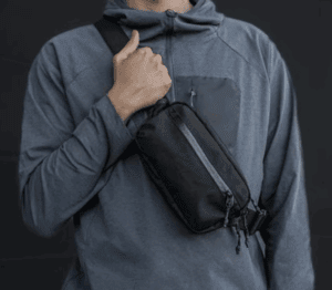 a person holding a black bag