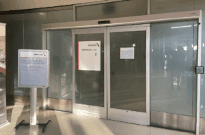 a glass doors with a sign on the front