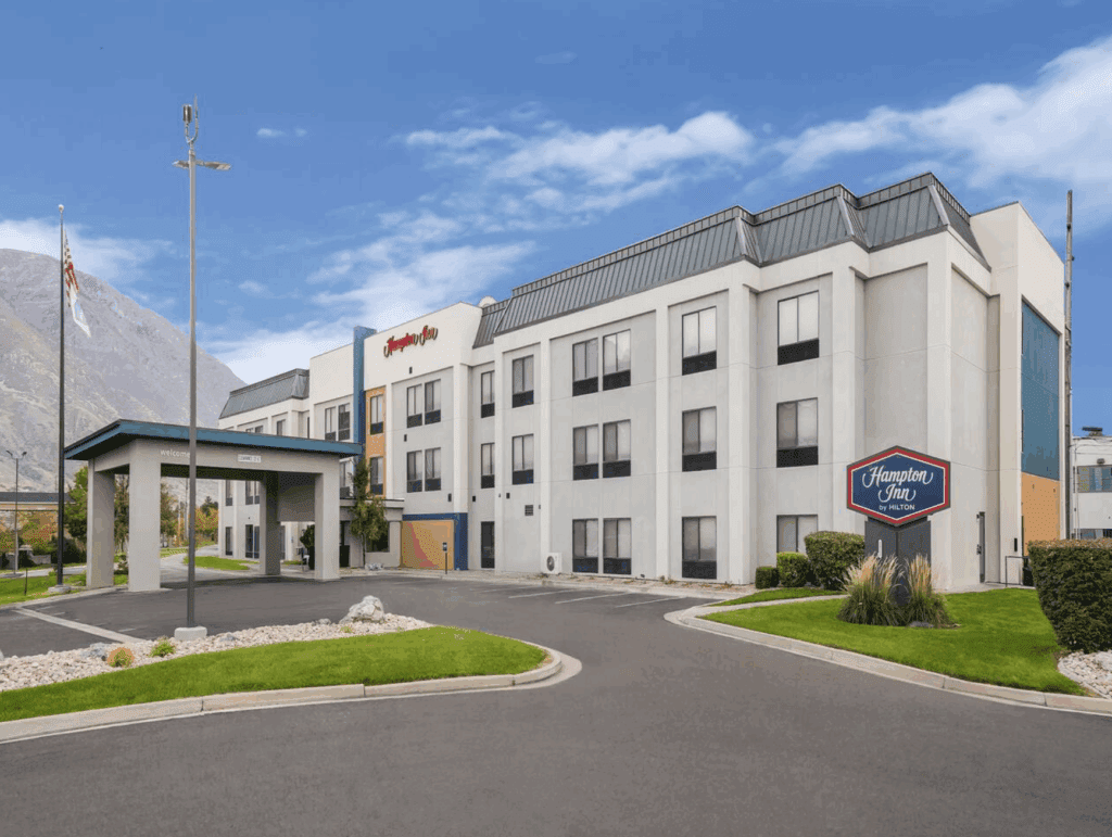 a building with a sign and a parking lot