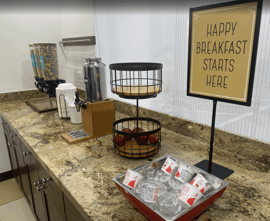 a breakfast buffet with a sign