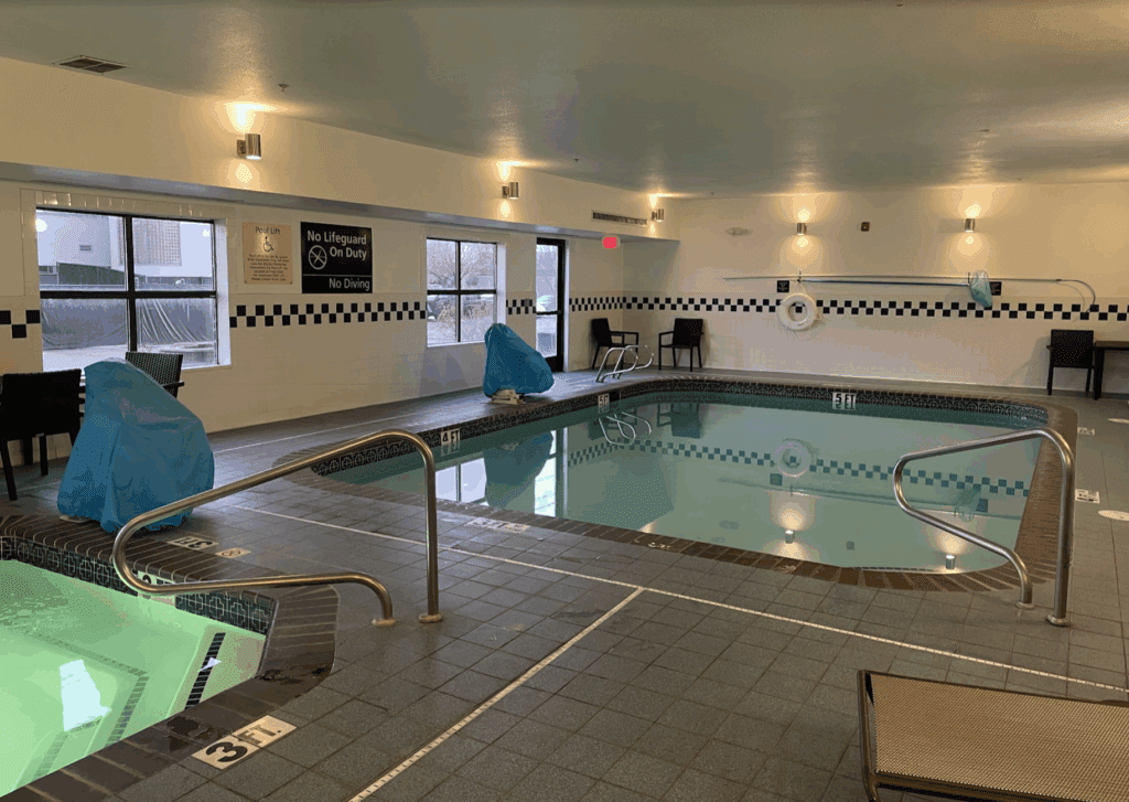 a indoor swimming pool with a railing
