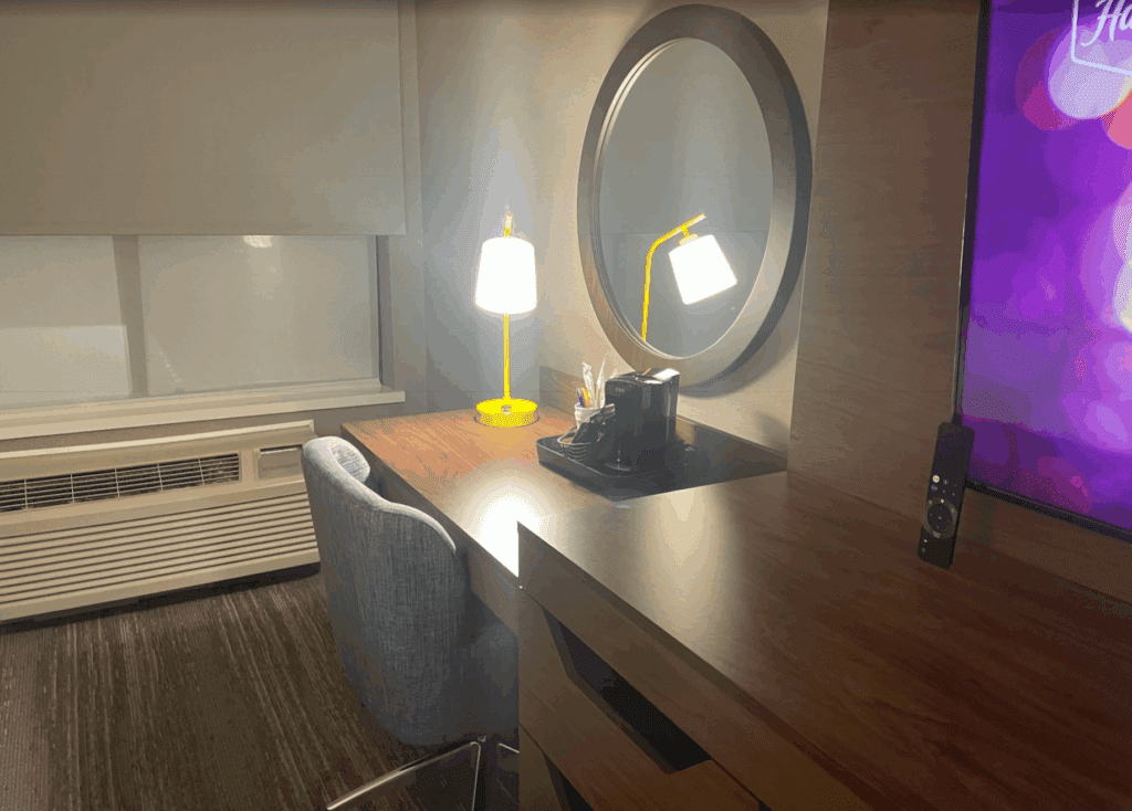 a desk with a lamp and a mirror