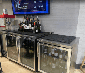 a bar with bottles of alcohol and glasses
