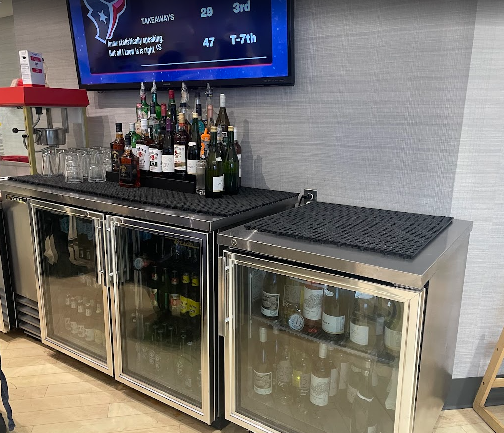 a bar with bottles of alcohol and glasses