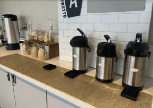 a row of coffee containers on a counter