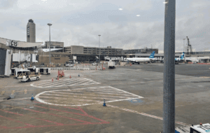 an airport with a plane in the background
