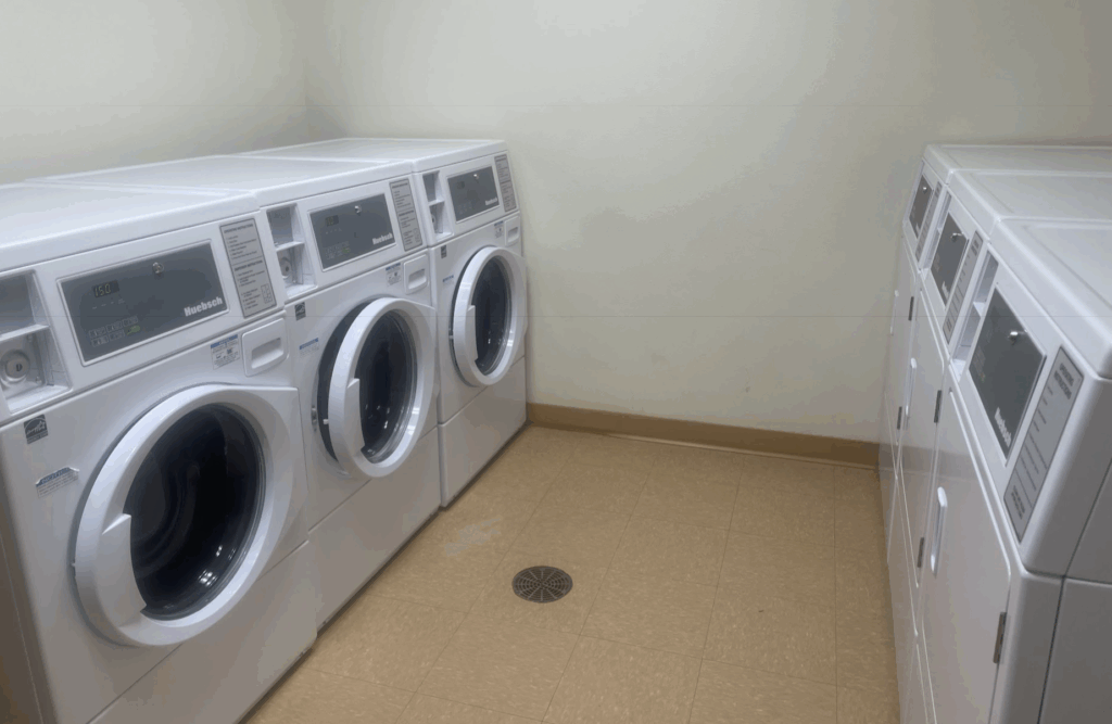 a laundry room with washers and dryers