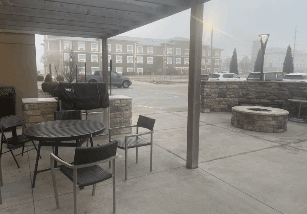 a patio with a table and chairs