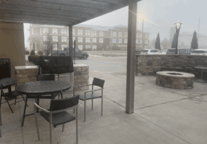 a patio with a table and chairs