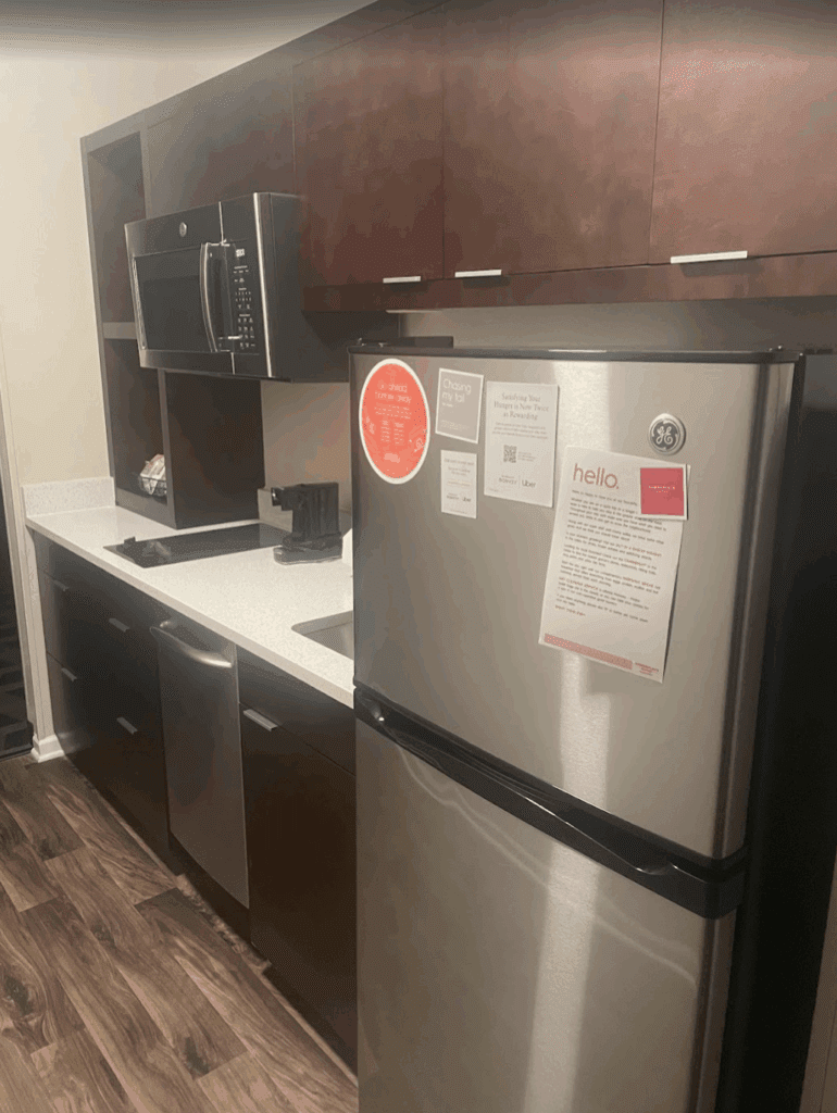 a kitchen with a refrigerator and microwave