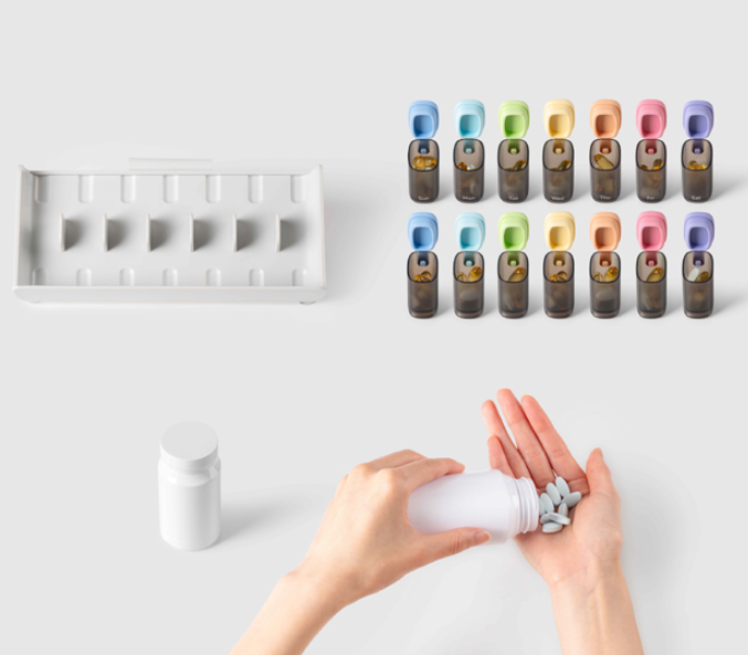 a hand holding a bottle of pills