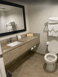 a bathroom with a marble countertop and a sink