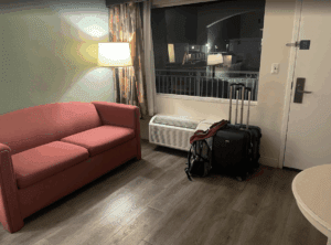 a room with a couch and luggage