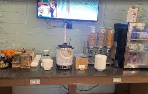 a breakfast buffet with a television and a coffee machine