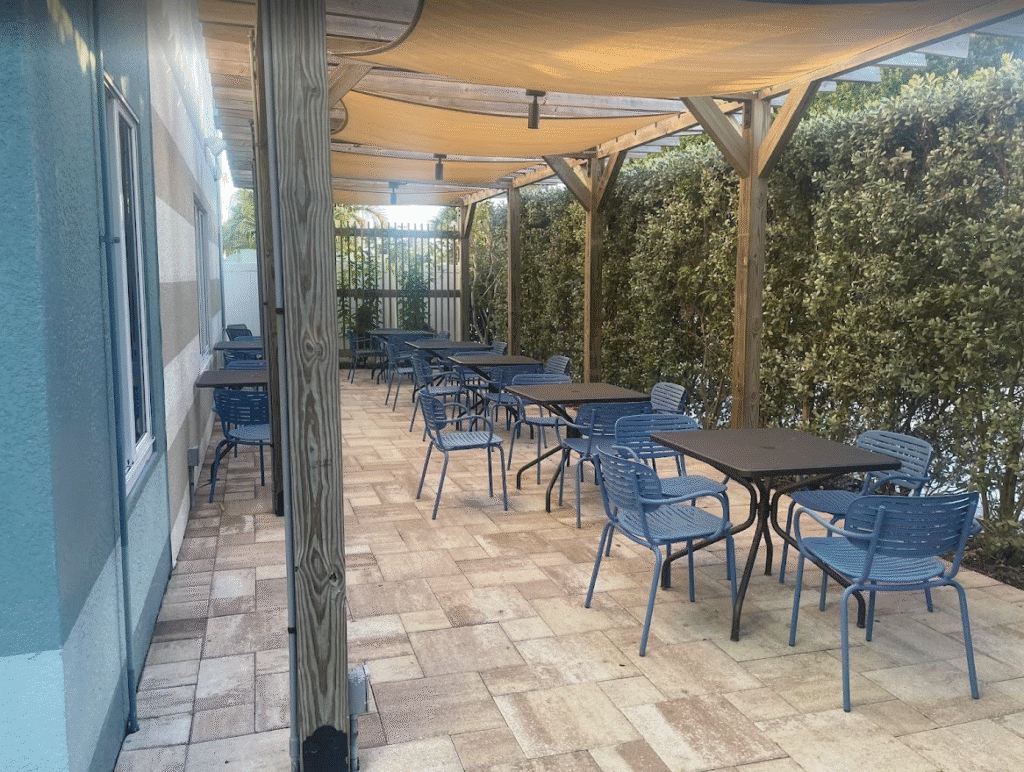 a patio with tables and chairs