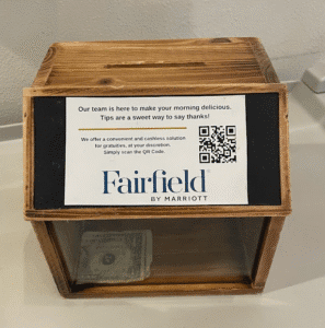 a wooden box with a paper money inside
