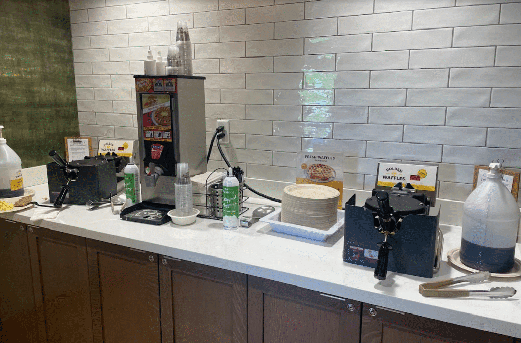 a counter with a machine and a waffle maker