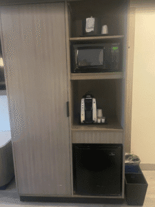 a cabinet with a microwave and coffee maker