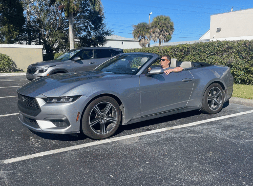 a man in a convertible car