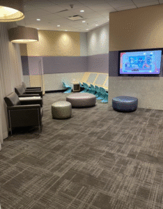 a room with chairs and a television