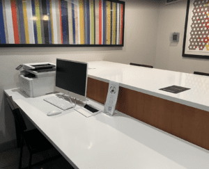 a white desk with a computer and printer